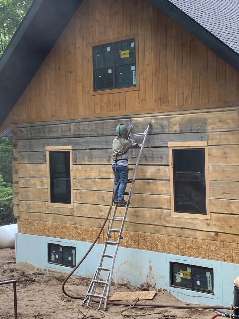 Sandblasting on old wood wall on a house. During sandblasting on old wood wall on a house.