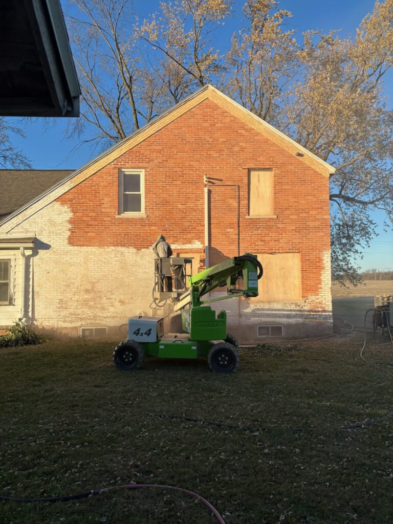 Sandblasting on old brick building During sandblasting on old brick building