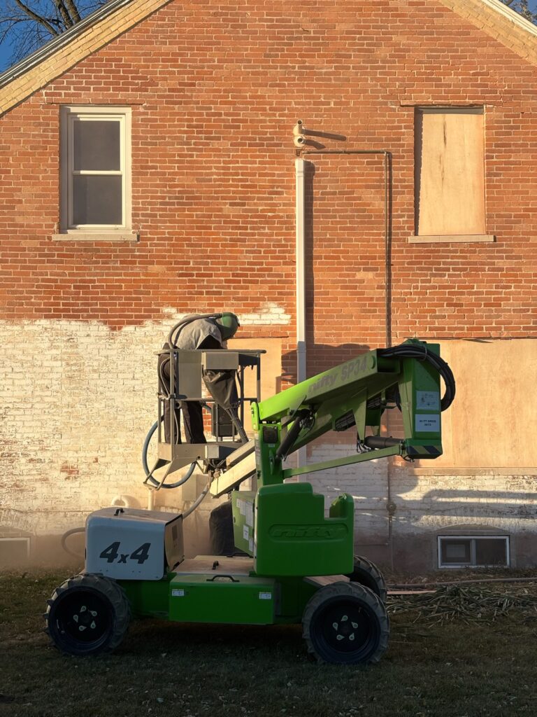 During sandblasting on old brick building During sandblasting on old brick building